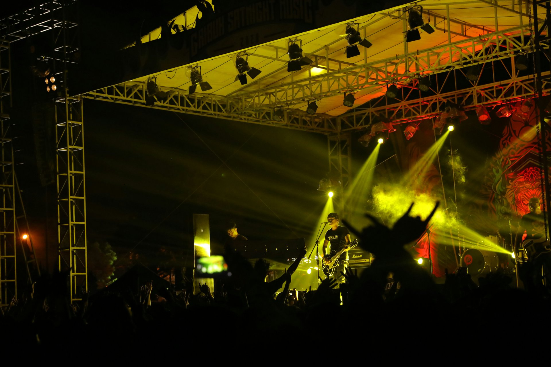 Open-air concert production with outdoor stage and audience